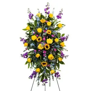 Funeral easel with yellow roses sunflowers and accents of lavender is a perfect expression of sympathy